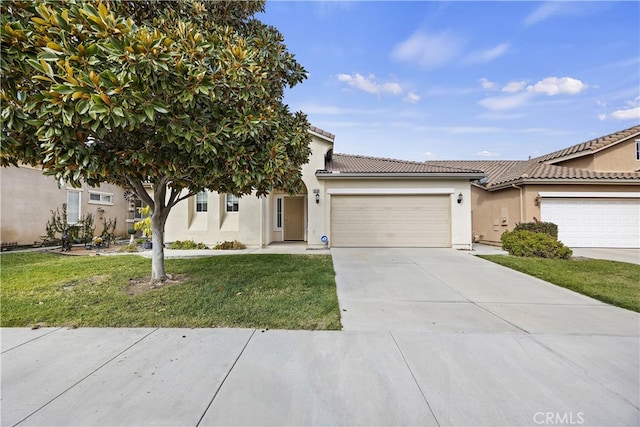 view of front of property with a garage and a front lawn