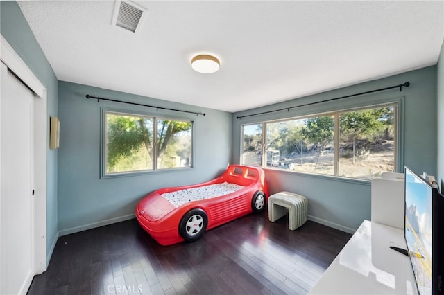 bedroom featuring dark hardwood / wood-style flooring and a closet