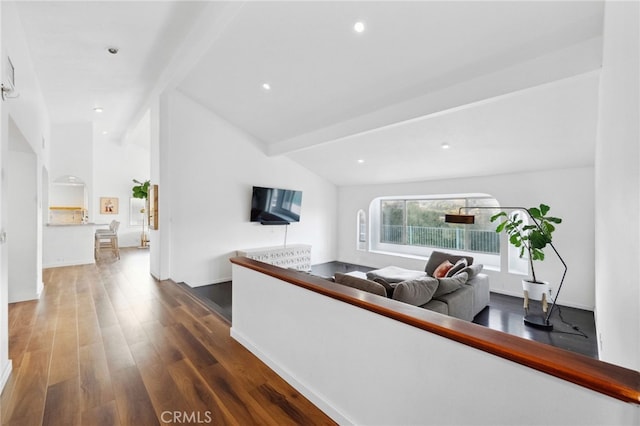 living room featuring vaulted ceiling with beams and hardwood / wood-style flooring