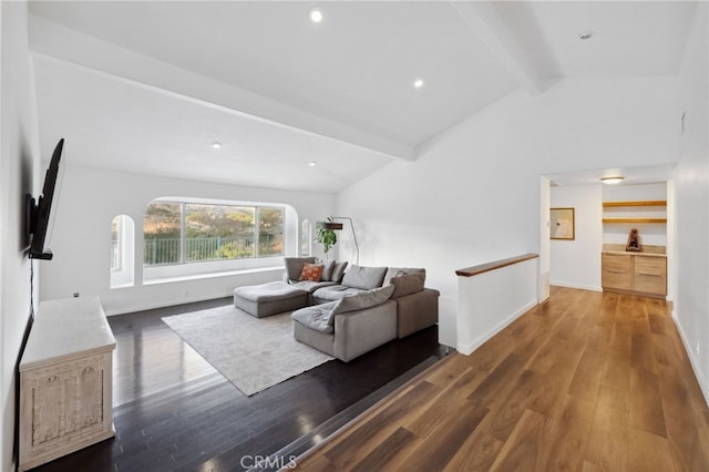 living room featuring dark hardwood / wood-style floors and lofted ceiling with beams