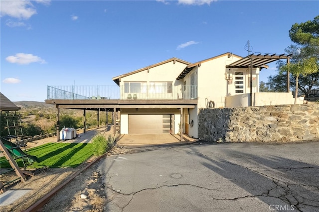 view of front of home featuring a garage and a balcony