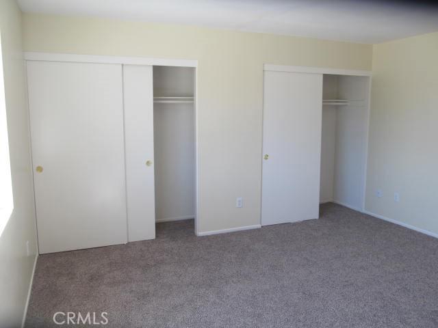 unfurnished bedroom featuring multiple closets and carpet flooring