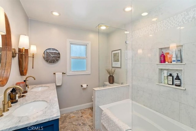 bathroom with tiled shower / bath and vanity