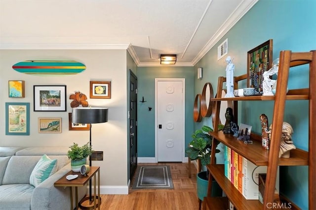 entryway with crown molding and parquet flooring