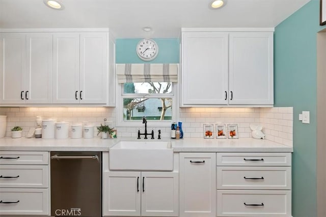 bar featuring tasteful backsplash, dishwasher, sink, and white cabinets