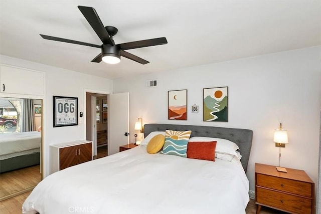 bedroom with hardwood / wood-style flooring and ceiling fan