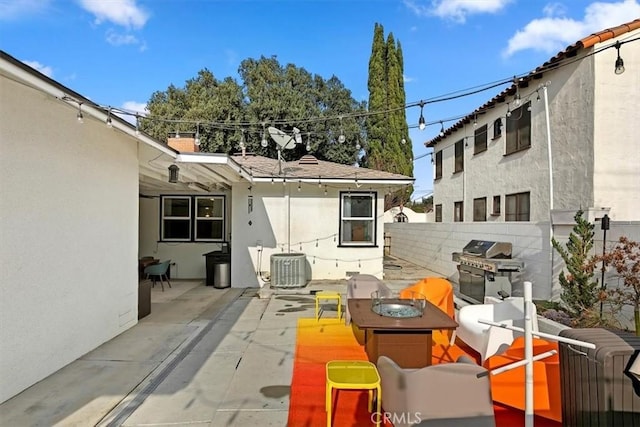 view of patio with a grill and cooling unit