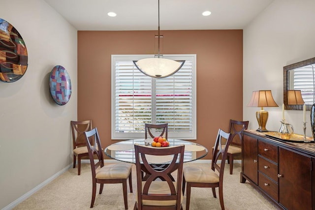 carpeted dining area with a healthy amount of sunlight