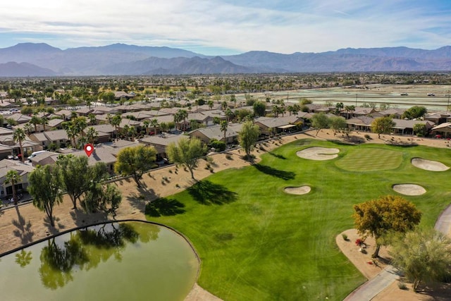 birds eye view of property with a water and mountain view