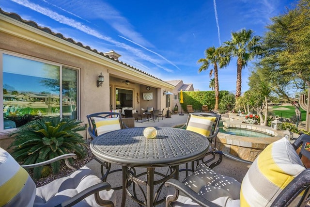 view of patio featuring a pool with hot tub