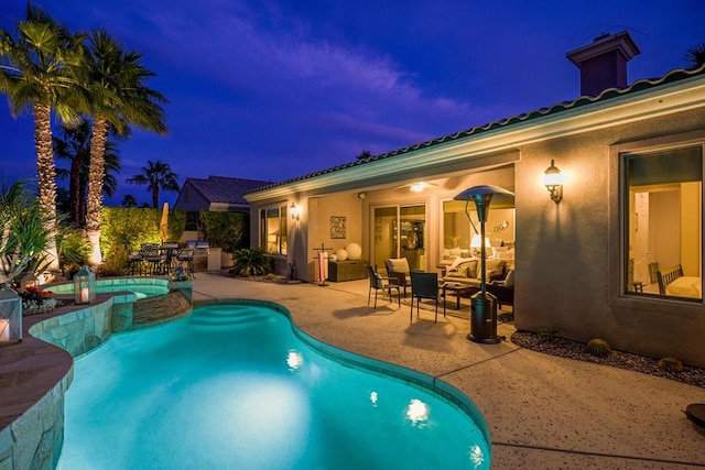 pool at dusk featuring a patio