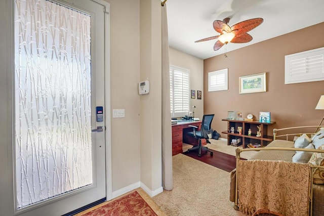 office space with ceiling fan and carpet