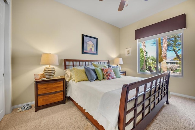 carpeted bedroom with ceiling fan and a closet