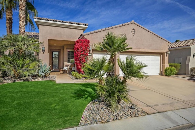 mediterranean / spanish home featuring a garage and a front yard