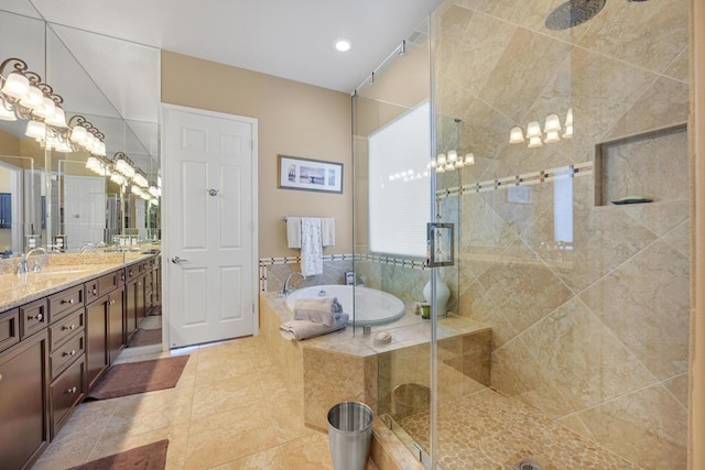 bathroom featuring vanity, separate shower and tub, and an inviting chandelier