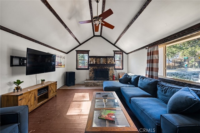 living room featuring a stone fireplace, vaulted ceiling, dark wood-type flooring, and plenty of natural light