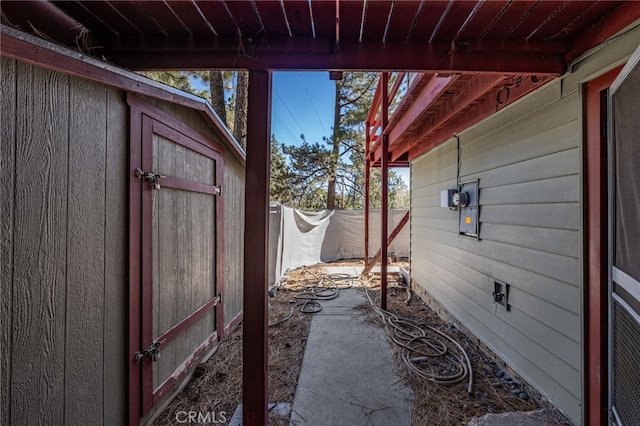 view of patio / terrace featuring a storage unit