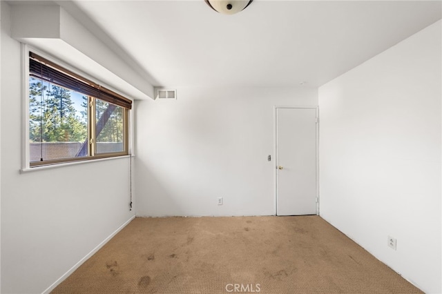 unfurnished room featuring carpet floors and visible vents