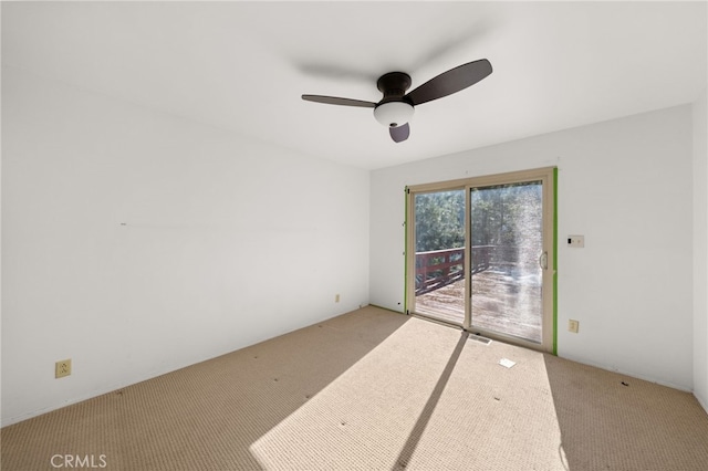 empty room with visible vents, carpet flooring, and a ceiling fan