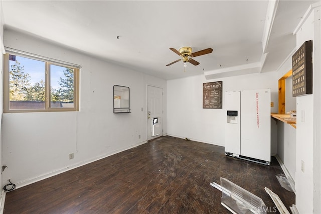 unfurnished living room with baseboards, a ceiling fan, and hardwood / wood-style floors