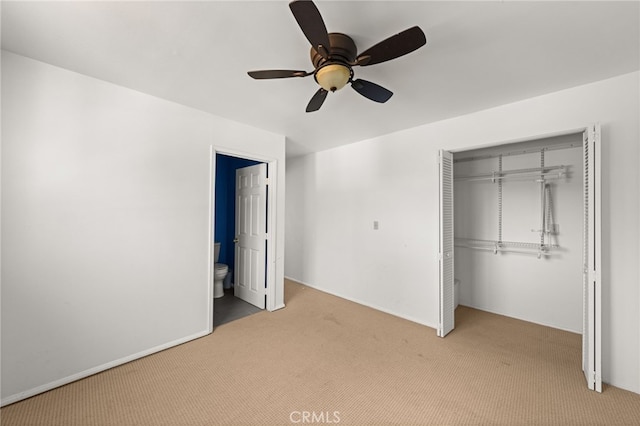 unfurnished bedroom with ceiling fan, connected bathroom, carpet flooring, and a closet