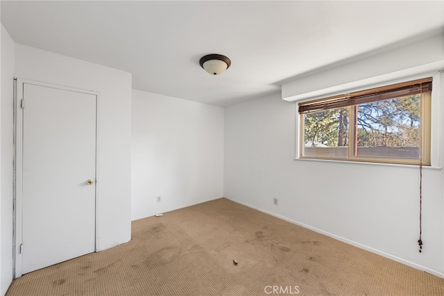 spare room featuring light colored carpet