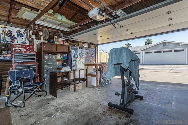 garage with a garage door opener and a workshop area