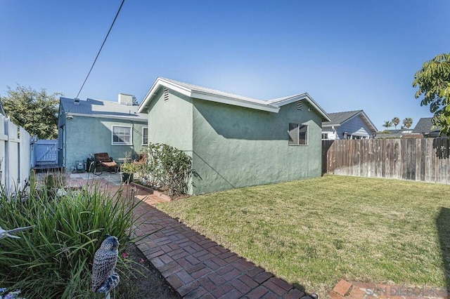 view of side of property with a yard