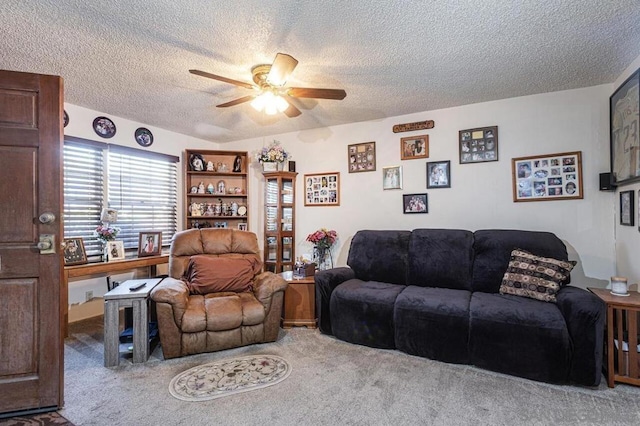 carpeted living room featuring a textured ceiling and ceiling fan