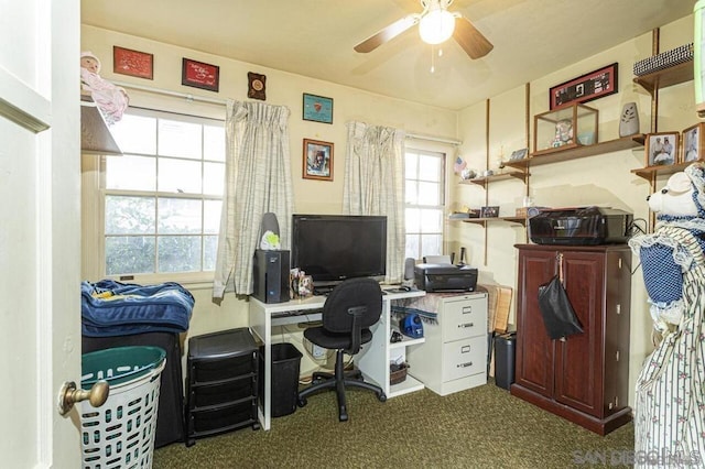 office space with dark carpet and ceiling fan