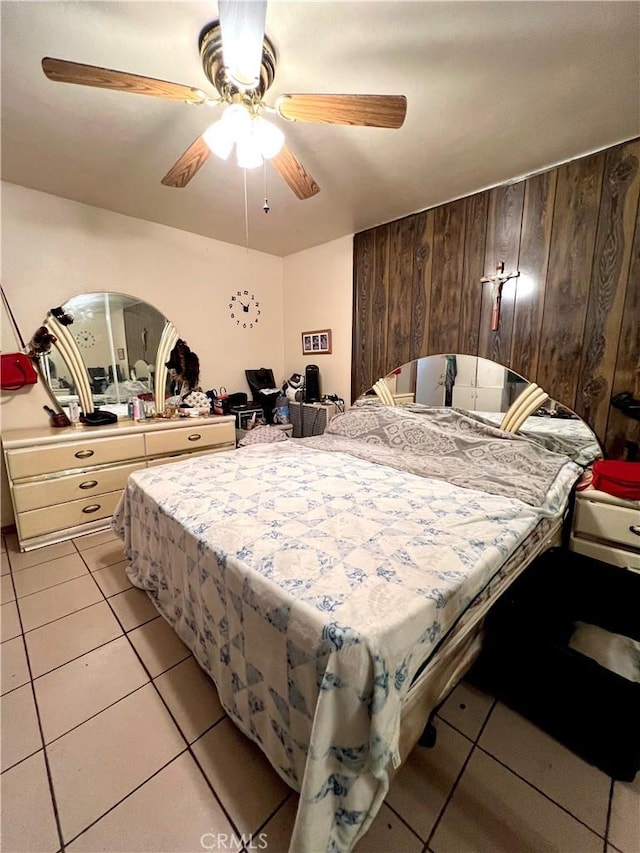 tiled bedroom with wooden walls and ceiling fan