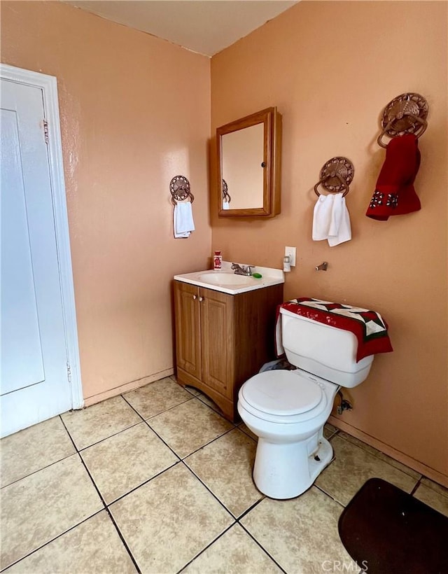 bathroom with vanity, tile patterned floors, and toilet