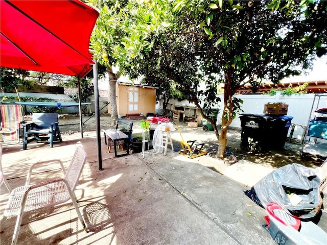 view of patio with a storage shed