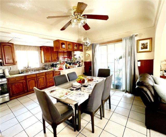 tiled dining space featuring sink and ceiling fan