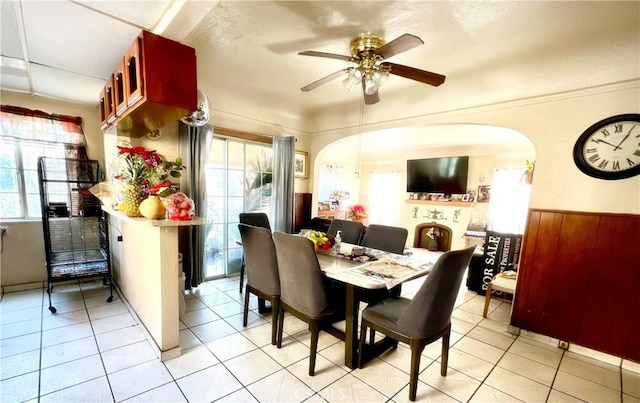 tiled dining room featuring ceiling fan