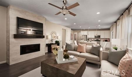 living room featuring ceiling fan and hardwood / wood-style floors