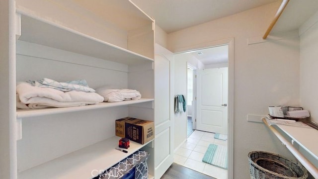 walk in closet with tile patterned floors