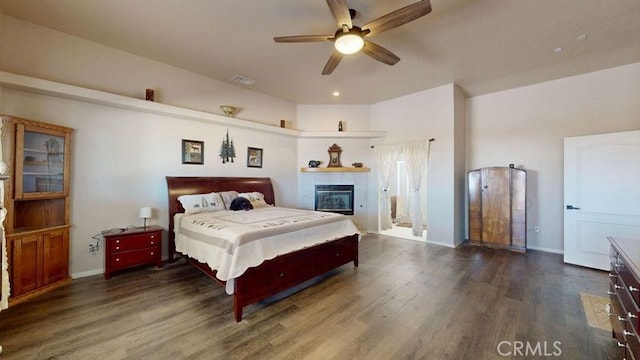 bedroom with dark hardwood / wood-style floors and ceiling fan