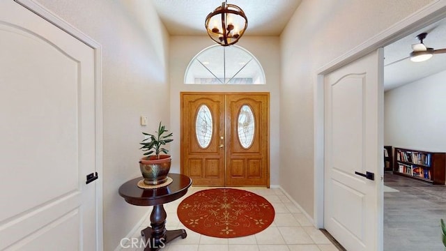 foyer with a chandelier and light tile patterned floors