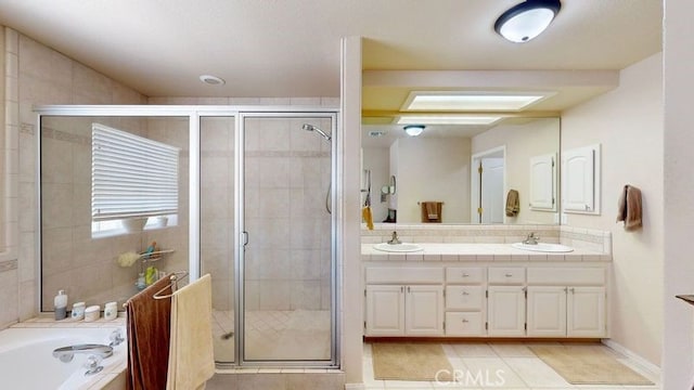 bathroom with tile patterned floors, vanity, and plus walk in shower