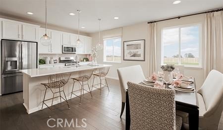 dining room with dark hardwood / wood-style flooring and sink