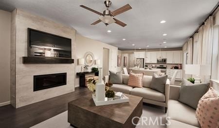 living room featuring ceiling fan and hardwood / wood-style floors