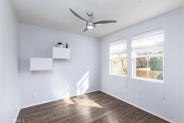 unfurnished room featuring dark wood-type flooring and ceiling fan