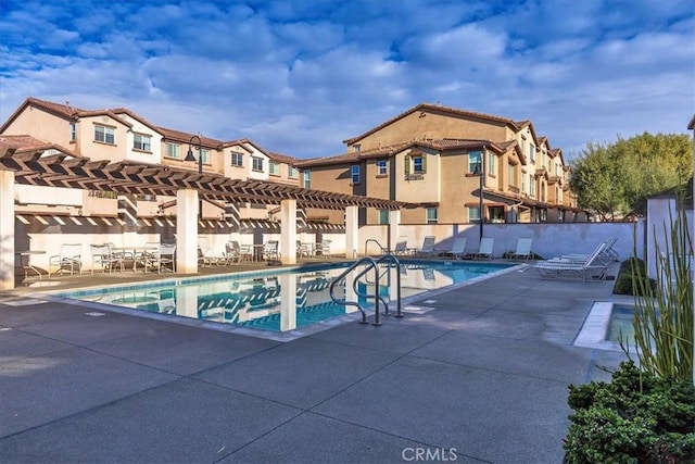 view of pool with a pergola and a patio area