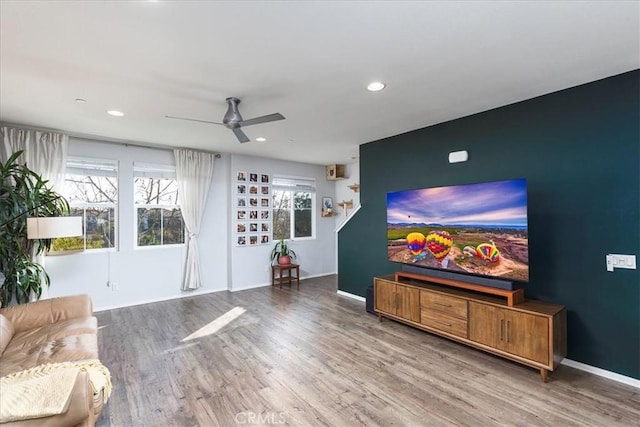 living room with hardwood / wood-style floors and ceiling fan