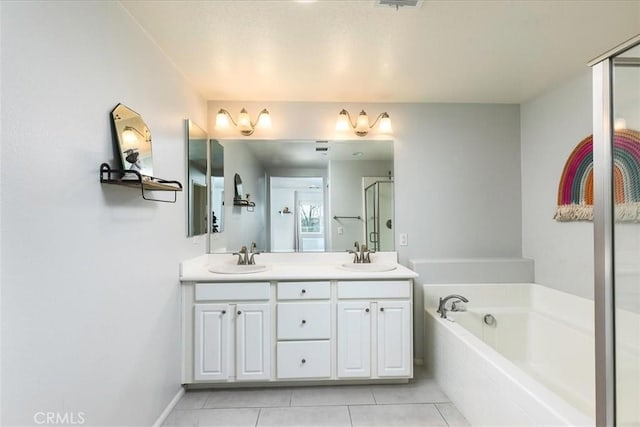 bathroom featuring tile patterned floors, vanity, and separate shower and tub