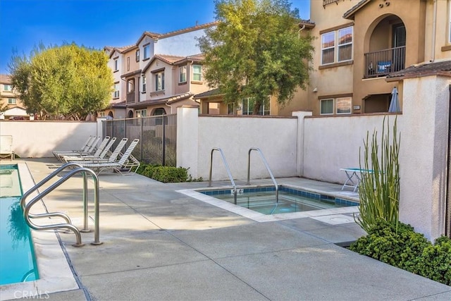 view of pool featuring a hot tub and a patio