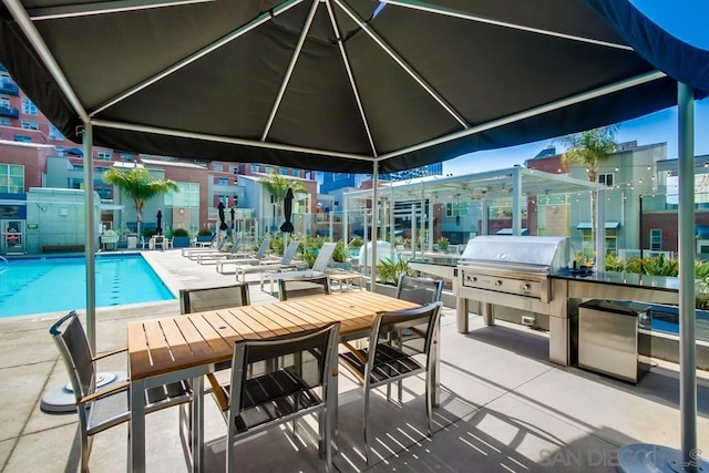 view of patio featuring a community pool and grilling area