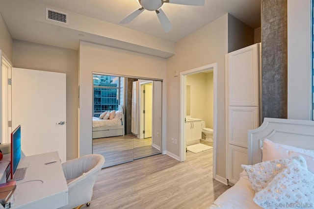 bedroom with ceiling fan, ensuite bath, a closet, and light wood-type flooring