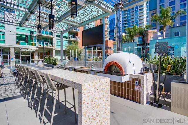 view of patio / terrace with area for grilling, grilling area, and exterior bar